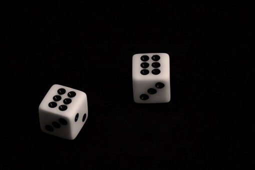 A pair of dice displaying sixes. 