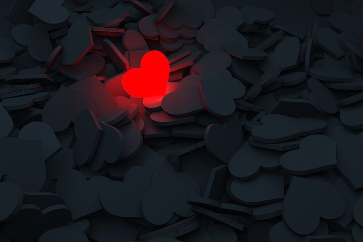 Image: One lit up red heart light among many dark ones. 